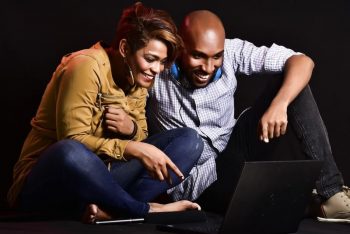 two people watching on a laptop